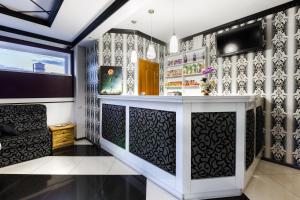 a bar in a home with black and white wallpaper at Everest in Ivano-Frankivsʼk