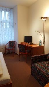 um quarto com uma secretária, um computador e uma cadeira em Hotel Restaurant Schlosschänke em Hannoversch Münden