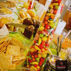 a table with a bunch of different types of food at Pampa Hotel in Vacaria