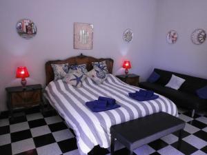 
a bedroom with a bed and a lamp on the wall at Salvone's house B&B in Giardini Naxos
