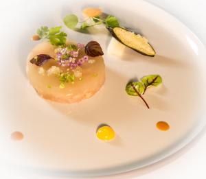 a plate of food on a white plate at Les Trois Soleils in Saint-Céré