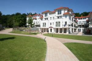 a large white building with a pathway in front of it at Haus Meeresblick A 2 23 Silberdistel mit Balkon in Baabe