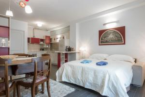 a bedroom with a bed and a desk and a kitchen at Borgo Guelfo VII in Florence
