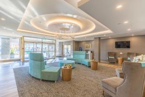 a lobby with blue chairs and a waiting room at Vittoria Hotel & Suites in Niagara Falls