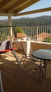 a deck with a table and chairs on a balcony at A Place To Remember in Ma‘alot