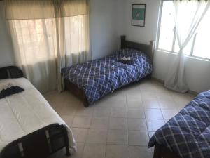Postel nebo postele na pokoji v ubytování Hostal Casa Lantana