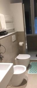 a bathroom with a white toilet and a sink at Camogli Golfo Paradiso la casa del Comandante in Camogli