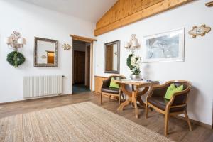 a living room with a table and two chairs at Appartements Spullersee in Lech am Arlberg