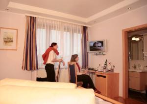 a man and woman standing in a hotel room at Retzerlandhof Familie Graf in Zellerndorf