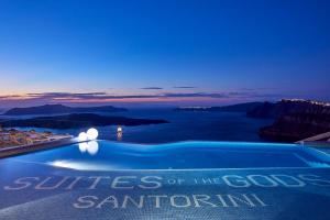 a swimming pool with the words suites of the gods santorini at Suites of the Gods Cave Spa Hotel in Megalochori