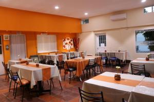 a dining room with tables and chairs in it at Hotel Pachá in Salta