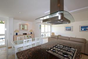 a kitchen and living room with a stove top at Marina Parque - Clever Details in Vilamoura