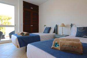 a bedroom with two beds with towels on them at Marina Parque - Clever Details in Vilamoura