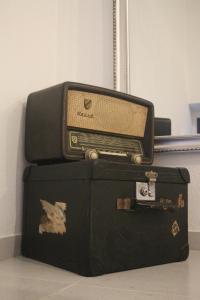 an old radio sitting on top of two suitcases at Nooks Sintra three in Sintra
