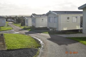 a row of mobile homes parked in a driveway at The Pearl in Poughill