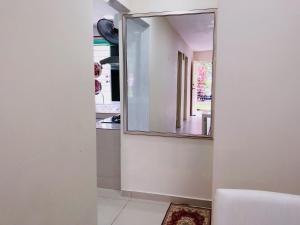 a mirror on the wall of a room with a kitchen at Homestay Farah Wangsa Maju KL in Kuala Lumpur