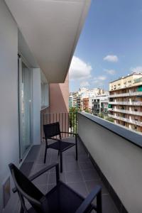 a balcony with two chairs and a view of a city at Fisa Rentals Les Corts Apartments in Barcelona