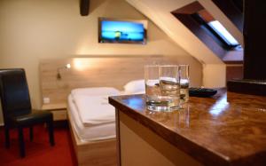 a glass of water on a counter in a hotel room at Hotel Stardust in Nové Zámky