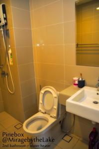 a bathroom with a toilet and a sink at PineBox Cyberjaya in Cyberjaya