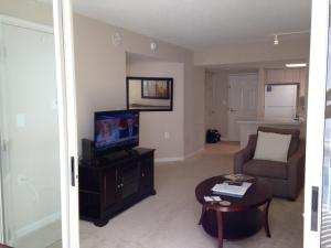 a living room with a television and a couch at National at Ballston Metro in Arlington