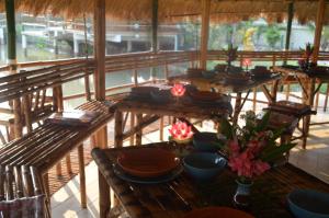 a group of tables with bowls and flowers on them at The Orchid Resort & Relax in Maha Sarakham