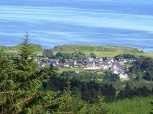 a small town on a hill near the water at Ashbank Hotel in Carradale