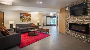 a living room with a couch and a fireplace at Best Western Monticello in Monticello