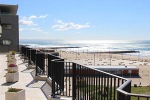 a view of the beach from the balcony of a condo at Rose's House in Costa da Caparica