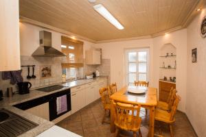 a kitchen with a wooden table and chairs at Ferienhaus-Pressler-Erfurt in Erfurt