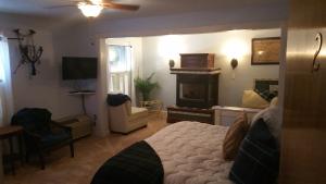 a bedroom with a bed and a fireplace at Woodstock Inn Bed & Breakfast in Independence