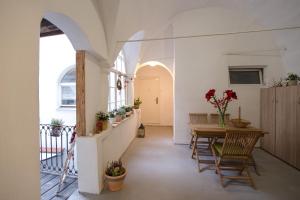 a hallway of a house with a table and chairs at Romantic Apartments Sweet Baci in Maribor