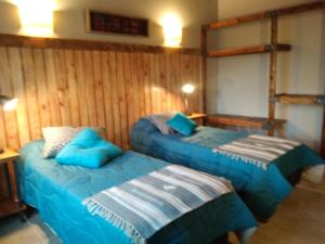 Postel nebo postele na pokoji v ubytování Hostal El Korú