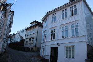 two white buildings sitting next to each other on a street at Skuteviksveien 42 in Bergen