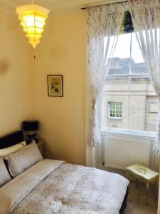 a bedroom with a bed and a large window at Royal Mile St Giles St in Edinburgh