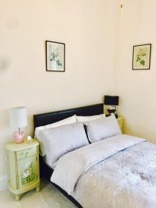 a bedroom with a bed and a table with a lamp at Royal Mile St Giles St in Edinburgh