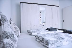 a bedroom with two beds and white cabinets at FW-Siegel in Singen