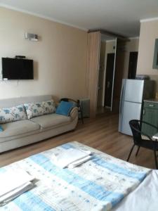 a living room with a couch and a refrigerator at Orbi Sea Towers Batumi on Khimshiashvili 15 in Batumi