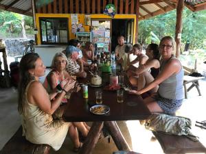 a group of people sitting at a table in a bar at KohChangResortRanong in Koh Chang Ranong