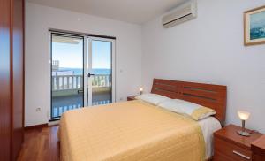 a bedroom with a bed and a large window at Luxury Residence Omis in Omiš