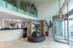 a man standing at a counter in a lobby at Quest on Durham in Tauranga