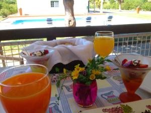a table with some food and some drinks on it at Herdade Do Rio Torto in Portel