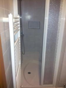 a shower with a glass door next to a toilet at Affittacamere Rosa Dei Venti in Levanto