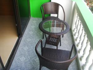 a couple of chairs sitting on a balcony at Kontiki Guesthouse in Jomtien Beach +1 photo