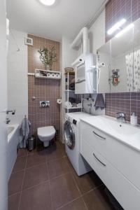 a bathroom with a sink and a washing machine at New Gallery Best West Apartment 101 in Zagreb