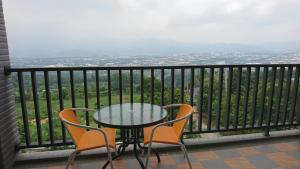 a table and chairs on a balcony with a view at Sun Moon Star in Xinshe