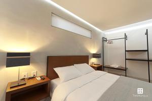 Un pat sau paturi într-o cameră la Hotel Urban 101