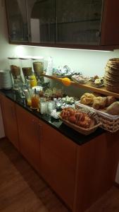 a buffet with a lot of food on a counter at Garni Kofler in Tirolo