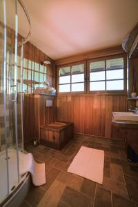 a bathroom with a shower and a sink at Villa Les with Hot tub & Sauna in Brežice