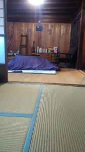 a room with a mattress on the floor of a room at Homestay at Remote Organic Farm in Nachikatsuura