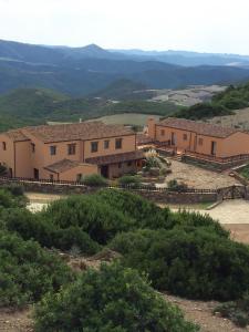 a group of buildings on top of a hill at L'Oasi del Cervo in Arbus